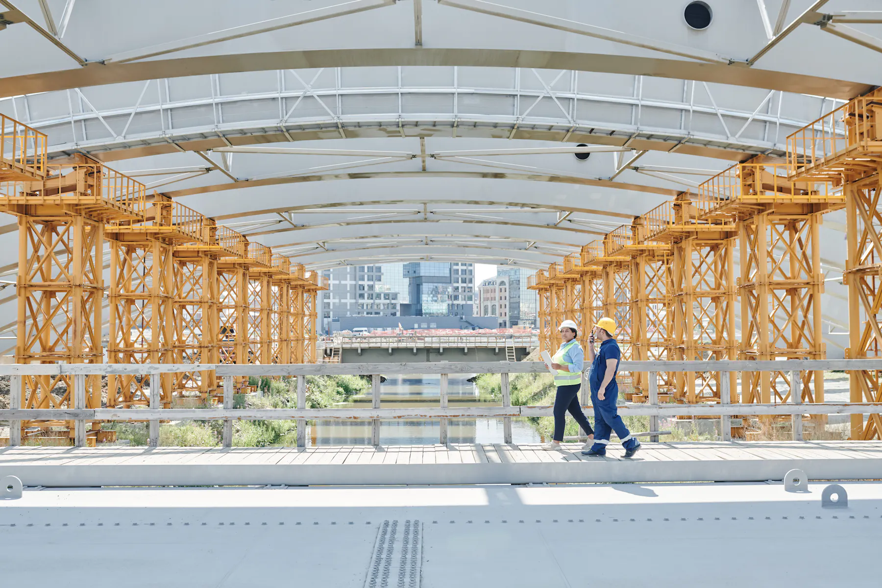 Construction professionals inspecting a major bridge project