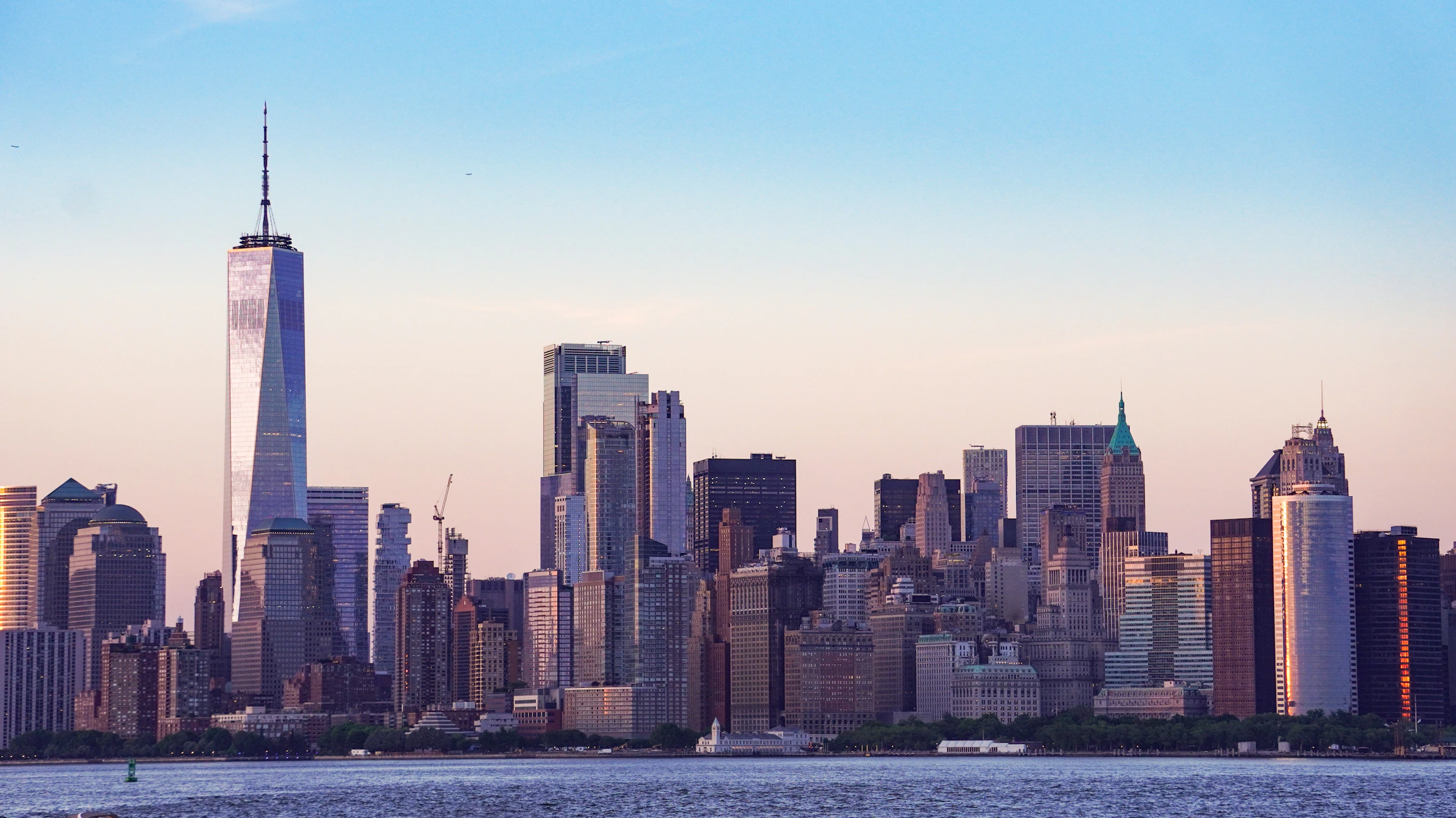 New York skyline with high-rise construction cranes at sunset